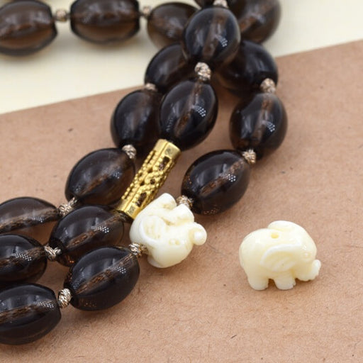 Buy Ivory white elephant resin bead 10x6mm - Hole: 1mm (1)